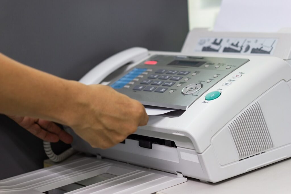 man usinga fax machine in the office