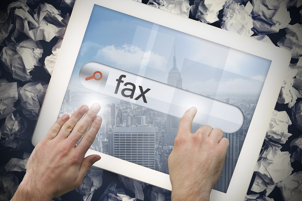 Hand touching fax on search bar on tablet screen