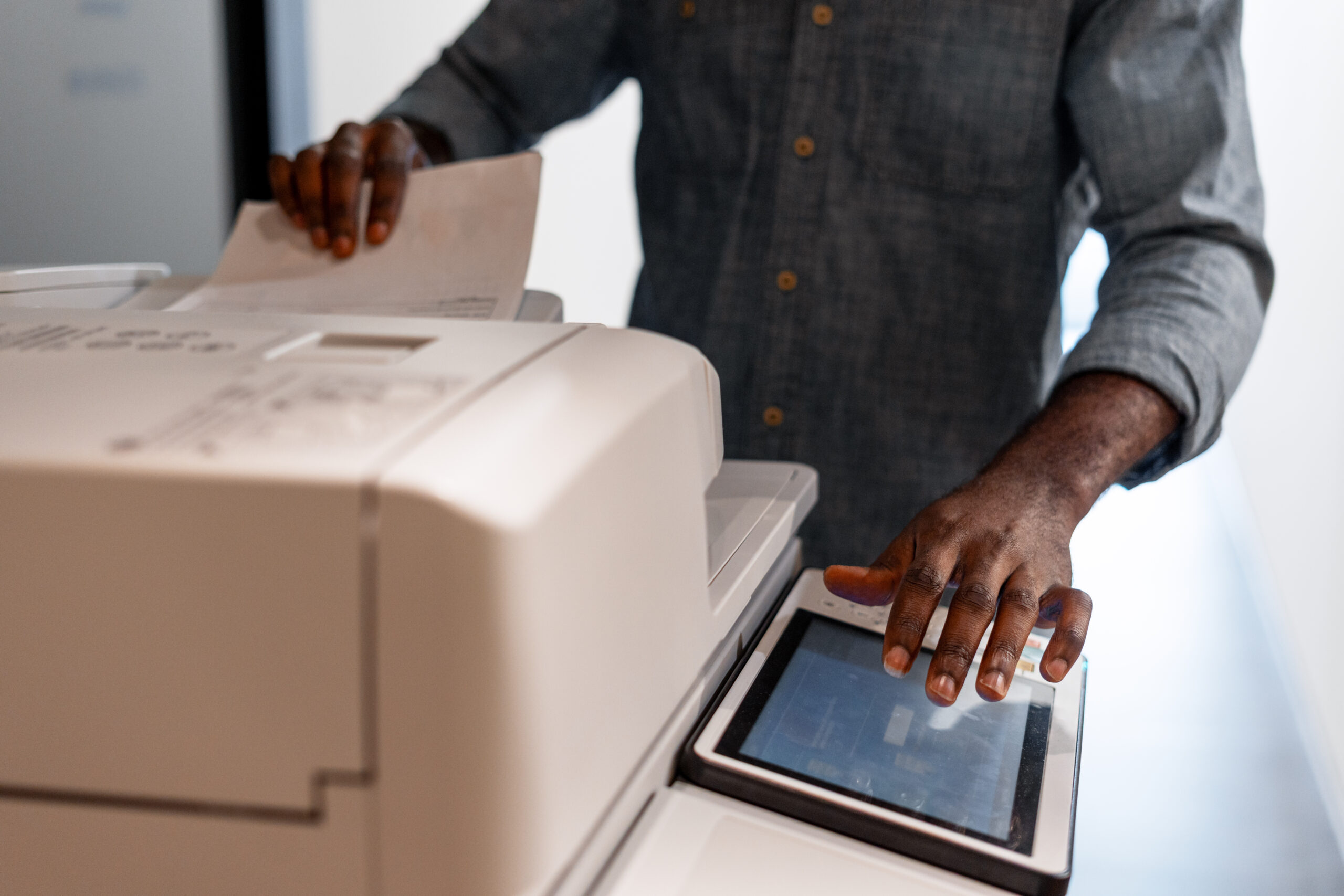 Office worker using a modern multifunction printer